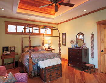 
The master bedroom unites native natural pecan wood flooring and an antique wood dresser and nightstand with more modern accessories, such as the blue vases, purchased at Pier 1 (www.pierone.com).
